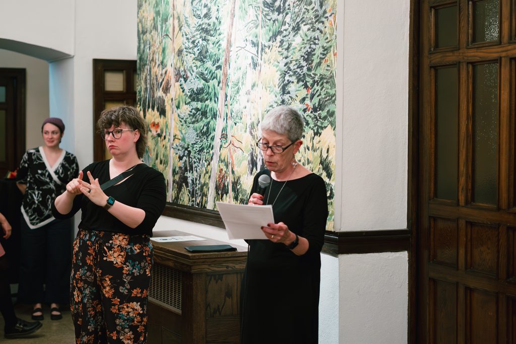 ASL interpreter interpreting a speech at a CUAG Centretown launch event